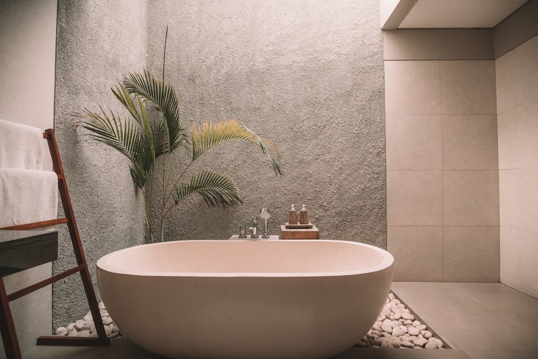 Spa-like bathroom with pale tile, natural wood and restrained accessories
